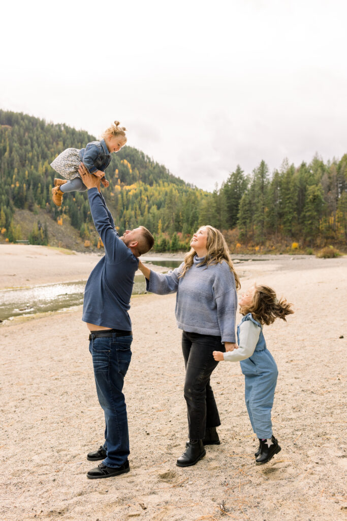 Toddler laughing while playing during a relaxed family photography session