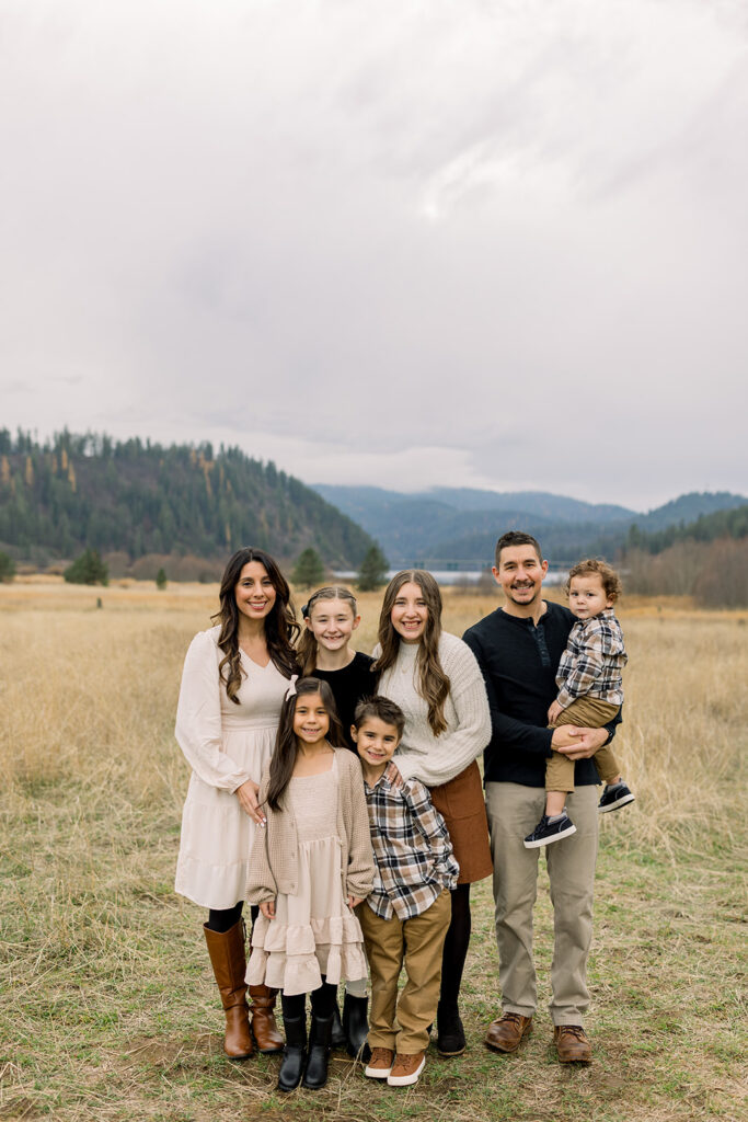 Family wearing soft neutral colors for a relaxed outdoor portrait session