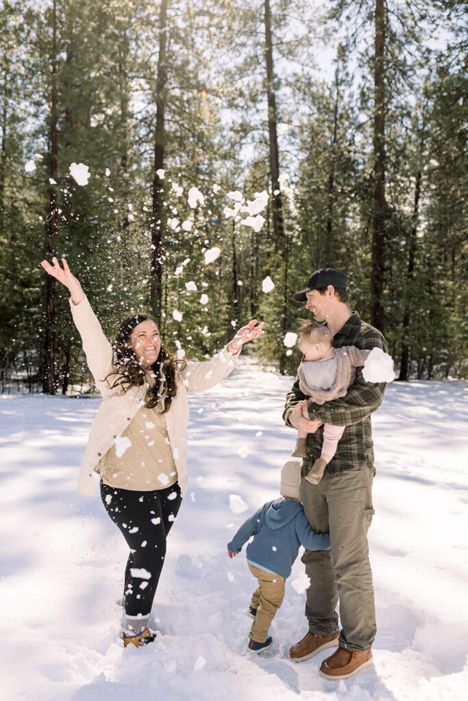 Family plays in the snow during North Idaho Family Photography session at Kiwanis Park
