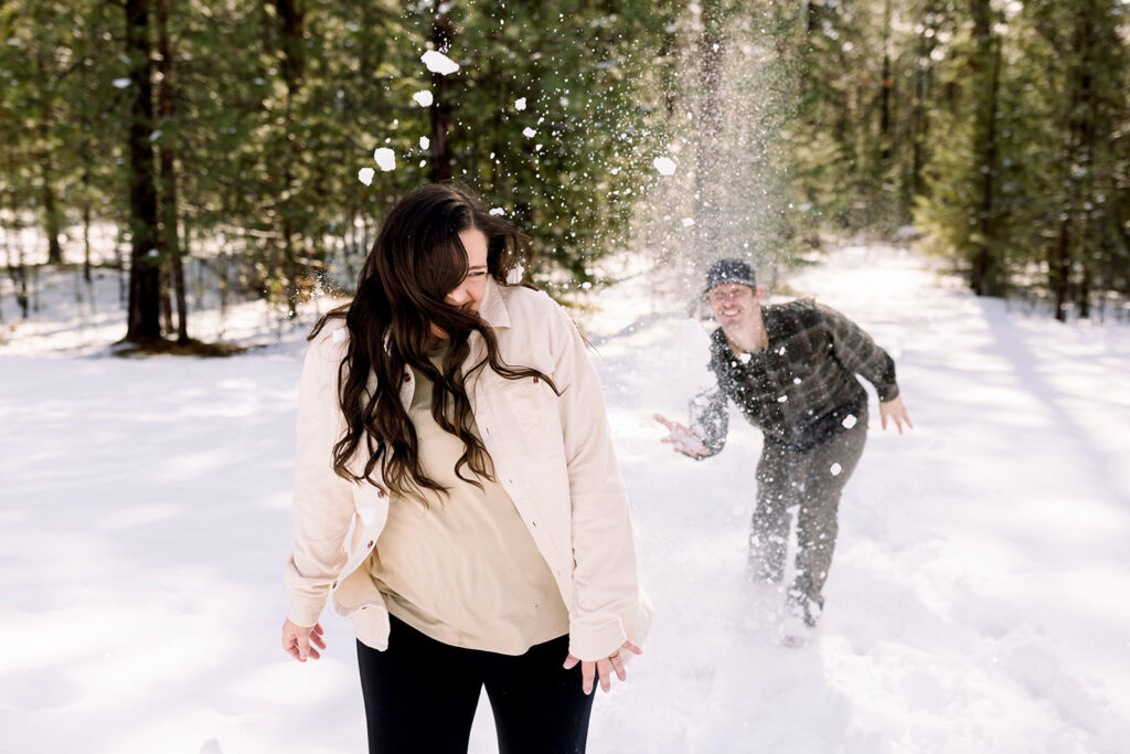 Mom and dad have a snow fight captured by coeur d'alene family photographer